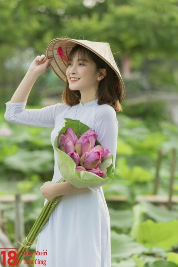 Cận cảnh bàn tay cô gái khẽ nâng niu một bông sen đang hé nở