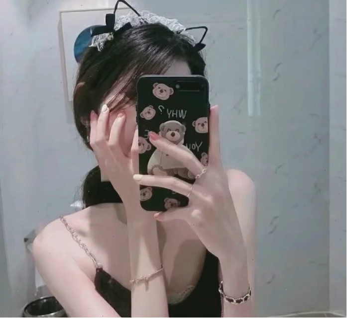 Cô gái bí ẩn che mặt bằng điện thoại khi nhìn vào gương