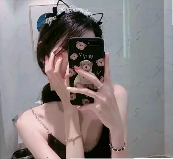 Cô gái che mặt bằng điện thoại trong phòng, tạo không gian riêng tư