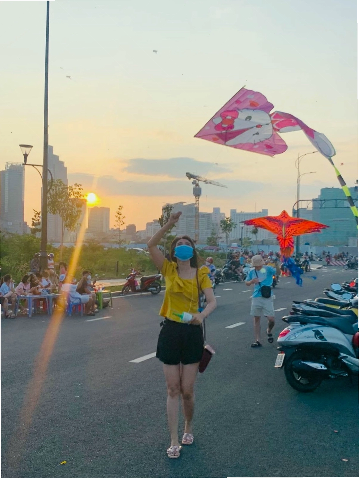 Phụ nữ hiện đại tham gia hoạt động thả diều ven sông